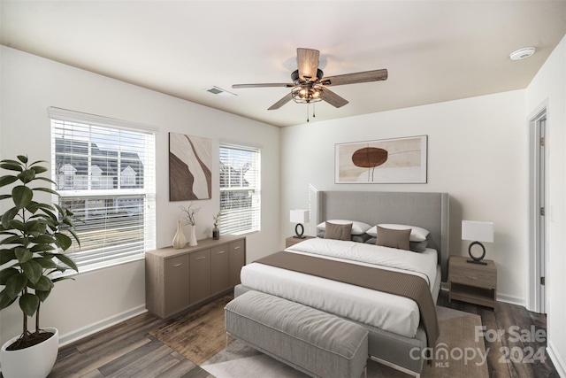 bedroom with dark hardwood / wood-style floors and ceiling fan