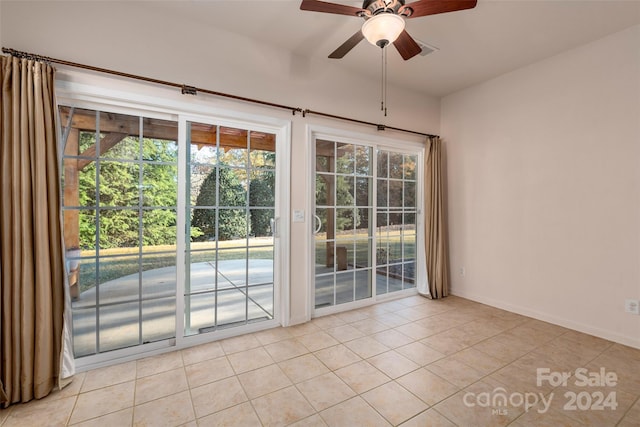 spare room with light tile patterned floors and ceiling fan