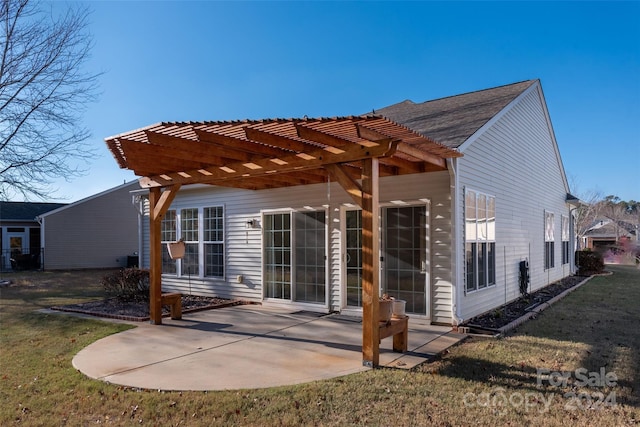 back of property featuring a pergola, a patio area, and a yard