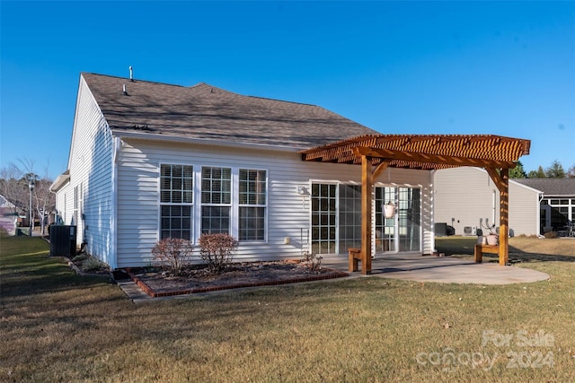 rear view of house featuring central AC unit, a pergola, a patio, and a lawn