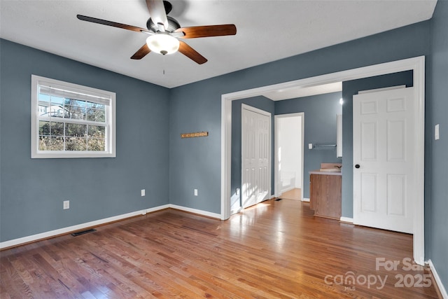 unfurnished room with ceiling fan and hardwood / wood-style flooring