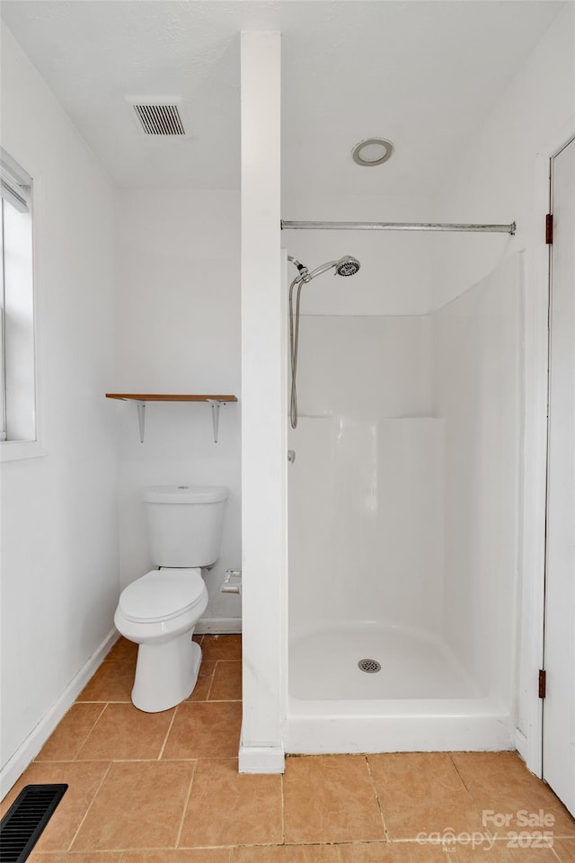 bathroom with toilet and walk in shower