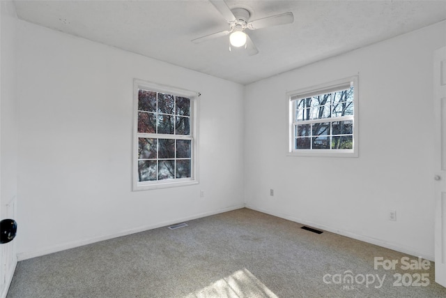 carpeted spare room with ceiling fan