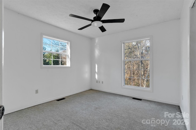 unfurnished room with carpet and ceiling fan