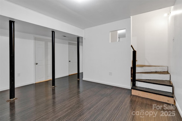 basement with dark hardwood / wood-style floors