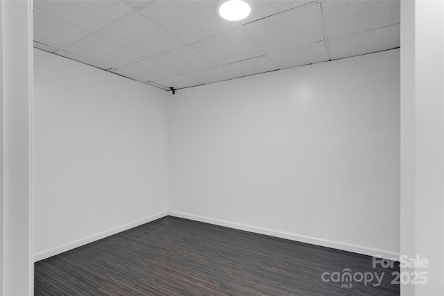 unfurnished room with a drop ceiling