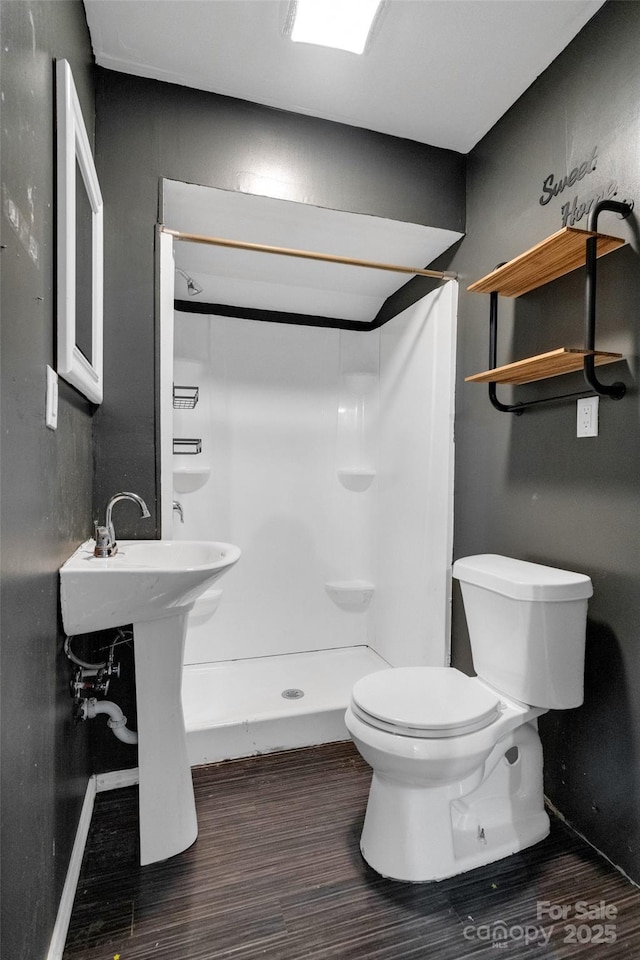 bathroom with a shower and toilet