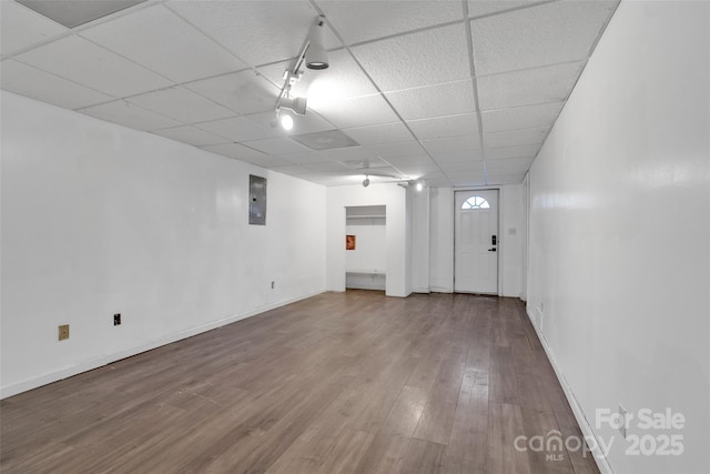 interior space featuring hardwood / wood-style floors, a drop ceiling, and electric panel