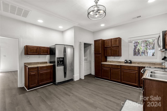 kitchen featuring dark brown cabinetry, dark hardwood / wood-style flooring, stainless steel appliances, and an inviting chandelier