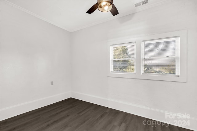 empty room featuring crown molding, dark hardwood / wood-style flooring, and ceiling fan