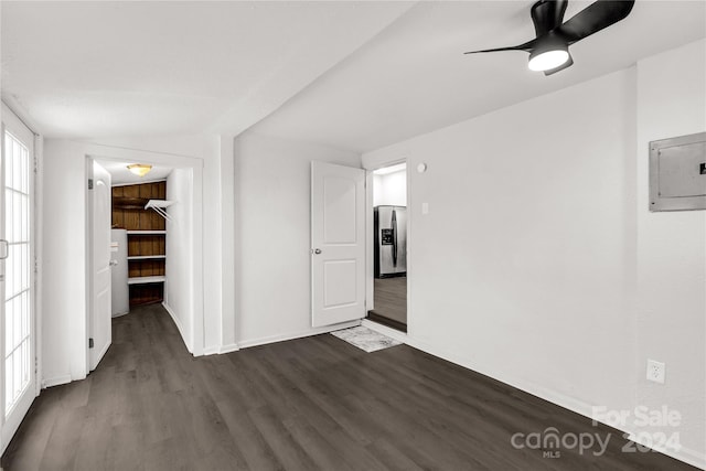 empty room with ceiling fan, lofted ceiling, dark wood-type flooring, and electric panel