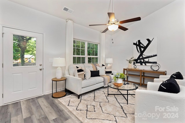 living room with light hardwood / wood-style floors and ceiling fan