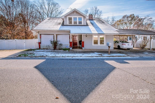 view of front of house with a carport and a porch