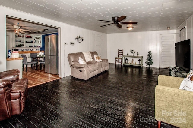 living room featuring ceiling fan and wood-type flooring