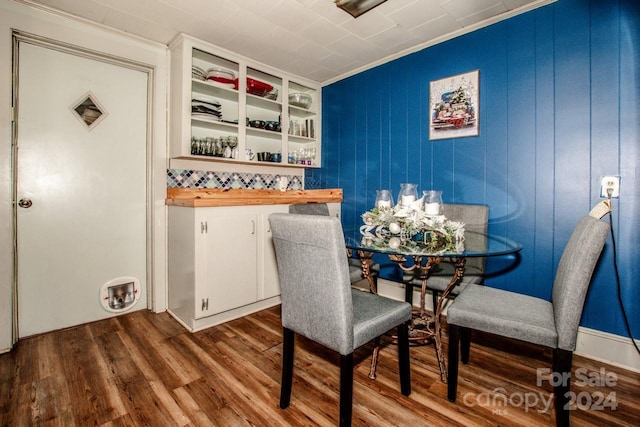 dining space featuring hardwood / wood-style flooring and ornamental molding