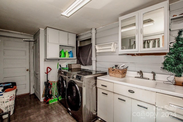 washroom featuring cabinets, dark parquet floors, washing machine and dryer, and sink