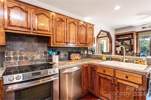 kitchen featuring backsplash, stainless steel appliances, dark hardwood / wood-style floors, and sink