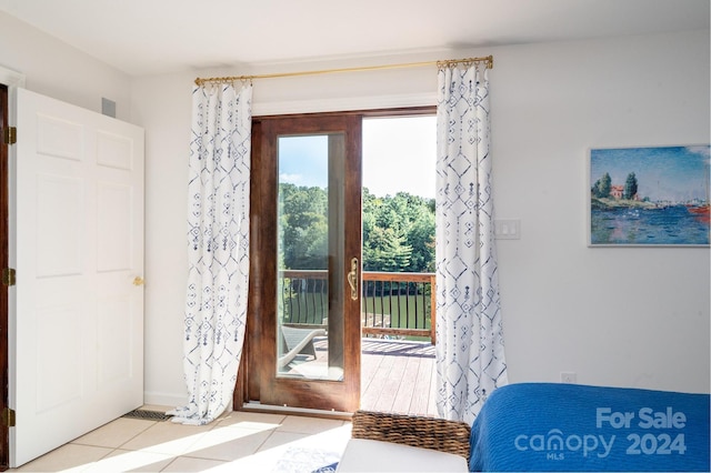 doorway to outside with light tile patterned flooring