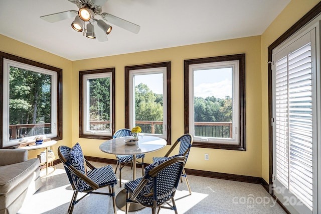 carpeted dining area with a wealth of natural light and ceiling fan