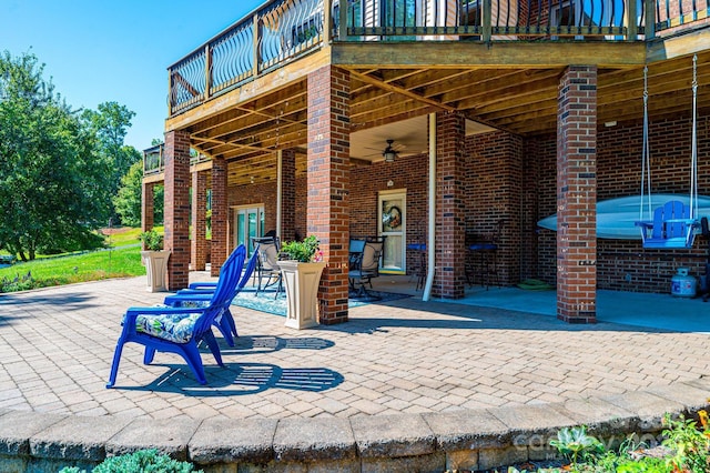 view of patio / terrace featuring ceiling fan and a balcony