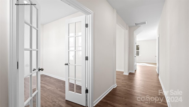 hall featuring french doors and dark hardwood / wood-style floors