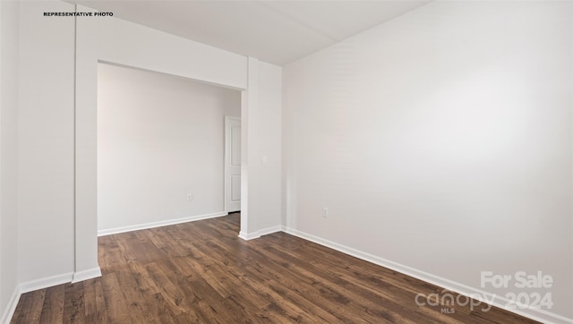 empty room with dark hardwood / wood-style floors