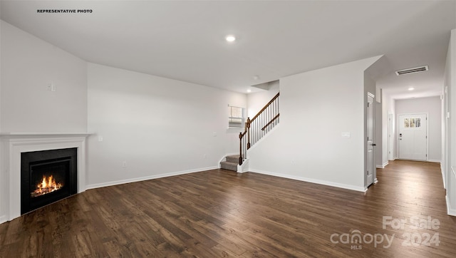 unfurnished living room with dark hardwood / wood-style floors