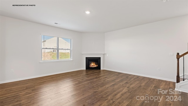 unfurnished living room featuring dark wood-type flooring