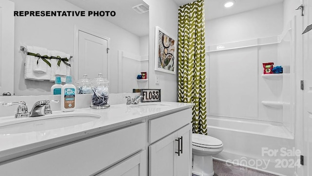 full bathroom featuring shower / bath combo with shower curtain, vanity, and toilet