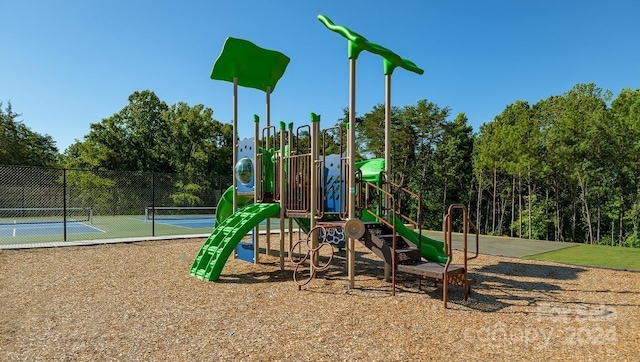 view of playground with tennis court