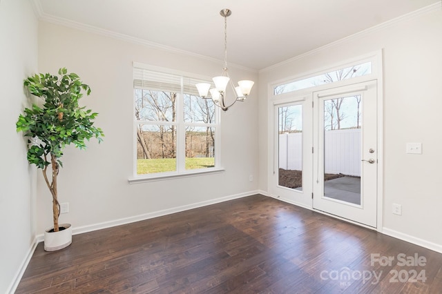 unfurnished dining area with ornamental molding, dark hardwood / wood-style flooring, and a notable chandelier