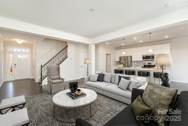 living room with dark wood-type flooring and crown molding