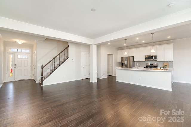 unfurnished living room with ornamental molding and dark hardwood / wood-style flooring