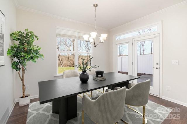 dining area with dark hardwood / wood-style flooring, crown molding, and a chandelier