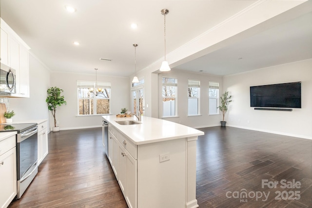 kitchen featuring white cabinetry, appliances with stainless steel finishes, sink, and a center island with sink