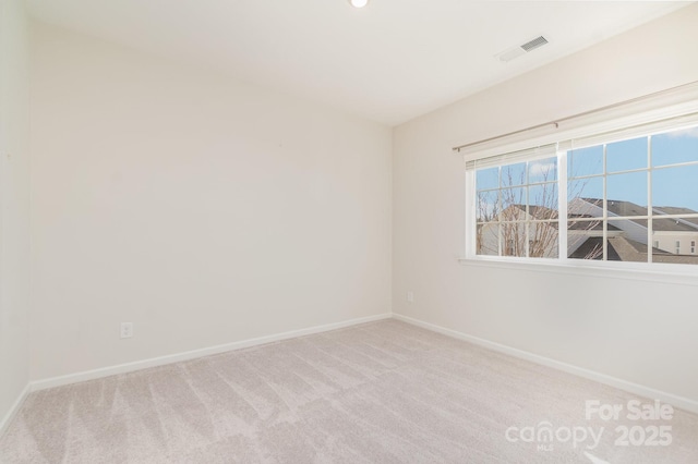 unfurnished room featuring light colored carpet