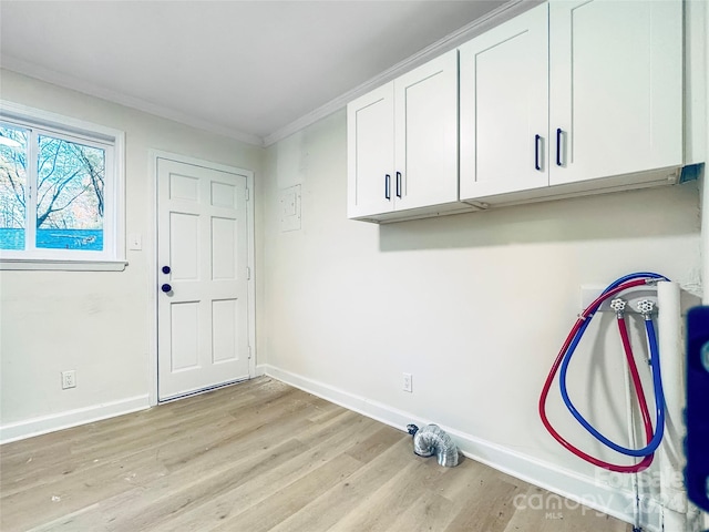 laundry room featuring cabinets, crown molding, hookup for a washing machine, and light hardwood / wood-style flooring