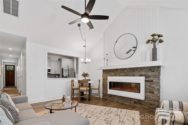 20 Heartleaf Cir Lot 7, Arden, NC 28704 - living room with wood finished floors, ceiling fan, a stone fireplace, a chandelier, and high vaulted ceiling