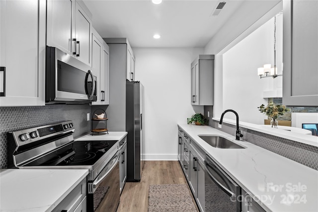 20 Heartleaf Cir Lot 7, Arden, NC 28704 - kitchen featuring stainless steel appliances, light wood finished floors, recessed lighting, backsplash, and light stone counters