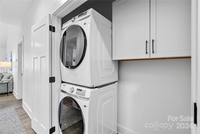 20 Heartleaf Cir Lot 7, Arden, NC 28704 - laundry area with stacked washer / drying machine, light wood-style floors, and cabinet space