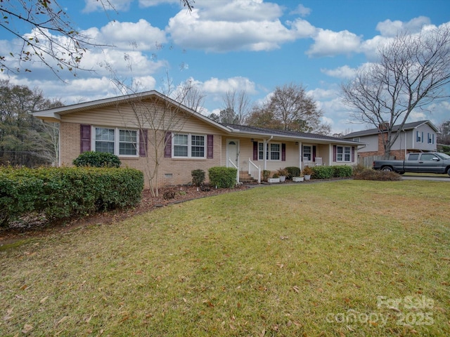 ranch-style house featuring covered porch and a front yard