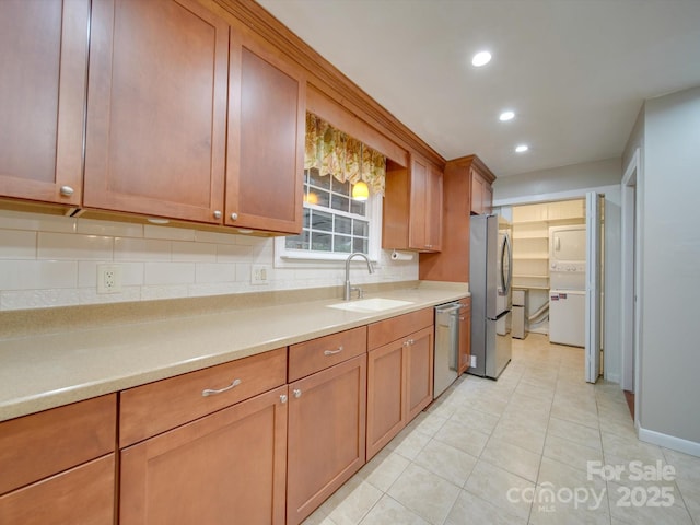 kitchen featuring light tile patterned floors, stainless steel appliances, tasteful backsplash, and sink