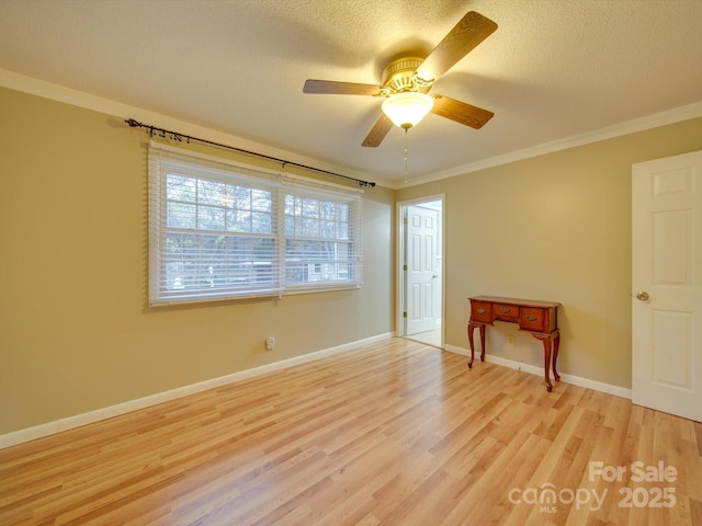 spare room featuring a textured ceiling, ceiling fan, crown molding, and light hardwood / wood-style flooring