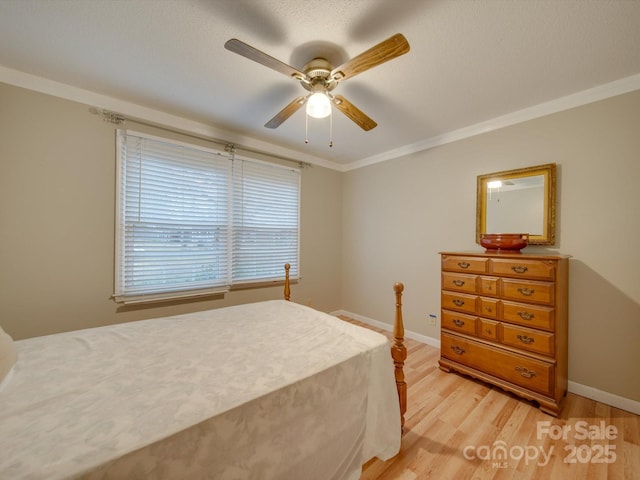 bedroom featuring ceiling fan, light hardwood / wood-style floors, and ornamental molding