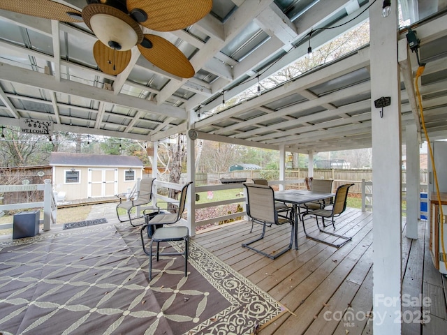 deck with ceiling fan and an outbuilding