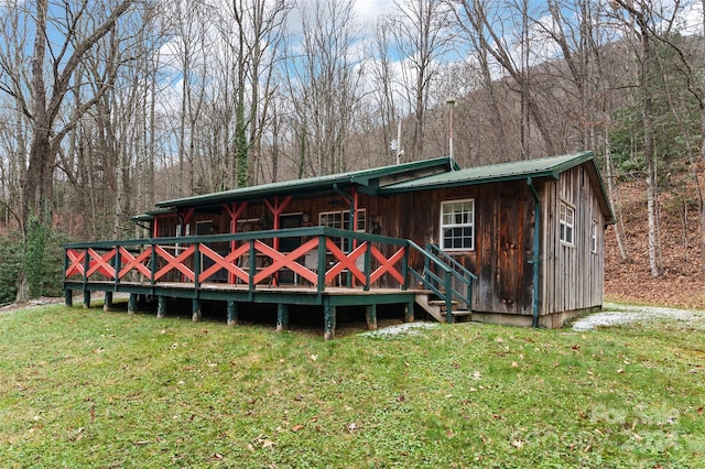 rear view of house featuring a yard