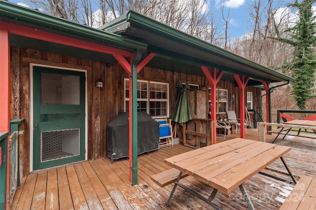 wooden terrace featuring a grill