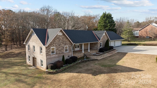 view of front of house featuring a front lawn, a porch, and a garage