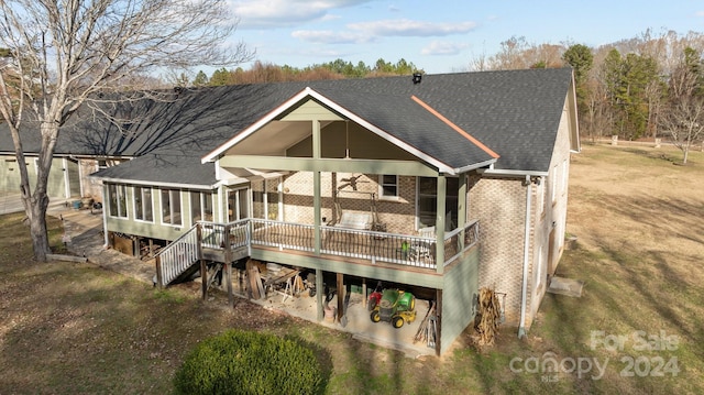 rear view of house featuring a wooden deck