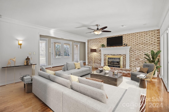 living room with light wood-type flooring, ornamental molding, and brick wall